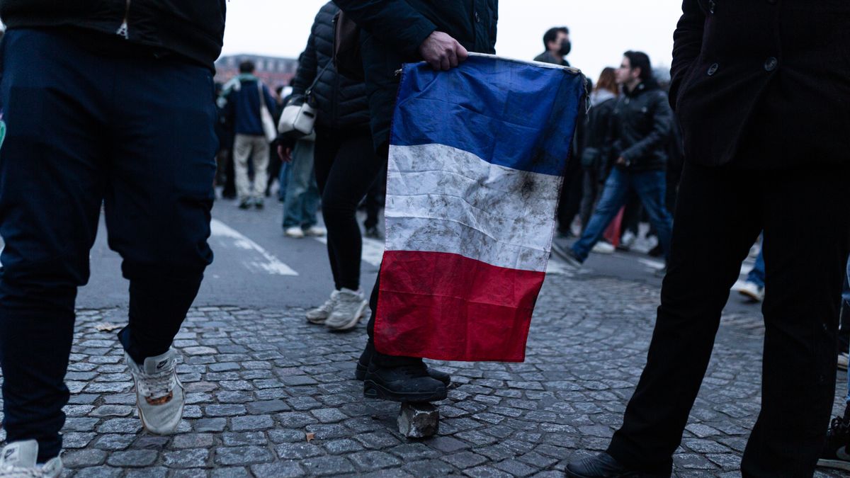 PARIS, FRANCE - 2023/01/31: A dirty France flag is seen during the demonstration against the new pension reform plan in Paris. A French pension reform strike took place for the second time this month where hundreds of thousands took the streets in Paris to pressure President Emmanuel Macron to drop the pension reform plan. (Photo by Telmo Pinto/SOPA Images/LightRocket via Getty Images)