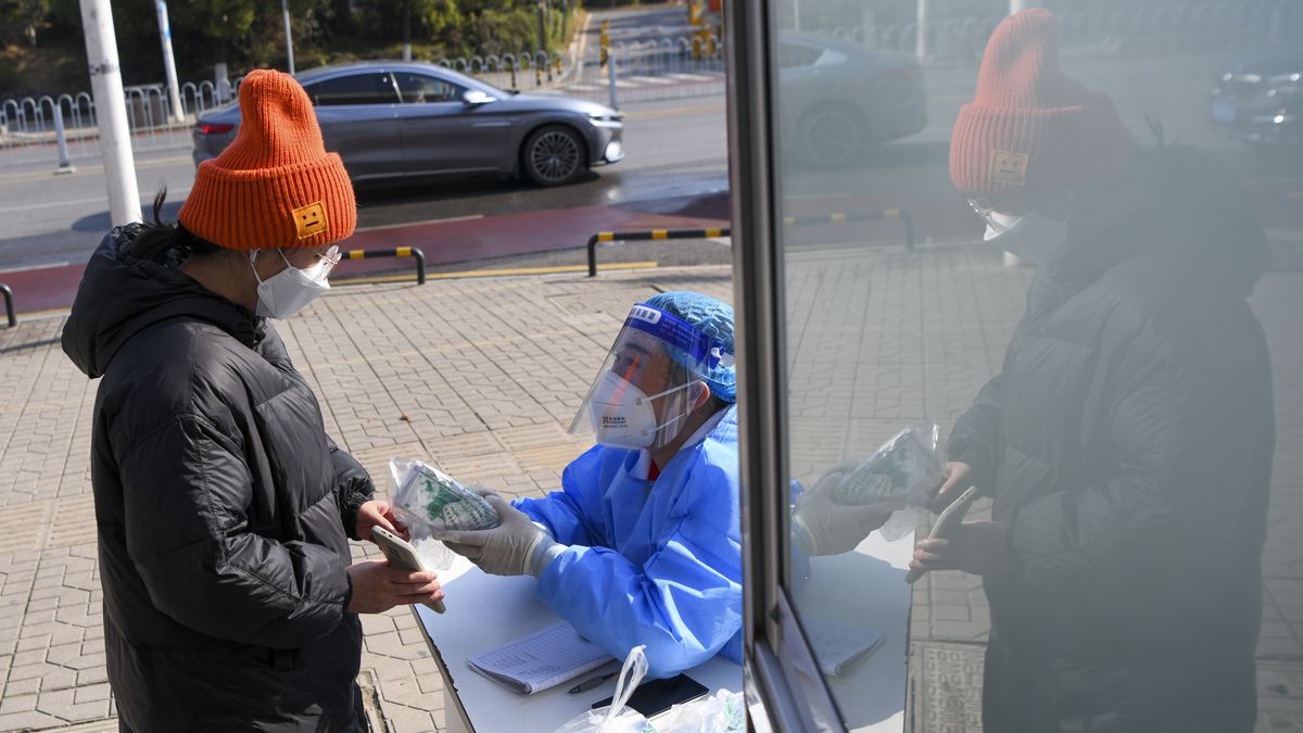 CHANGSHA, CHINA - DECEMBER 23: A medical worker distributes free health kit packages for COVID-19 prevention and control at a community health center on December 23, 2022 in Changsha, Hunan Province of China. The first batch of 100,000 free health kit packages have been distributed, each containing 9 tablets of fever reducing drugs and 2 antigen test kits. (Photo by Yang Huafeng/China News Service/VCG via Getty Images)