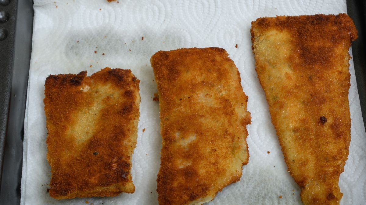 Ryba odsączana z nadmiaru tłuszczu na ręczniku papierowym