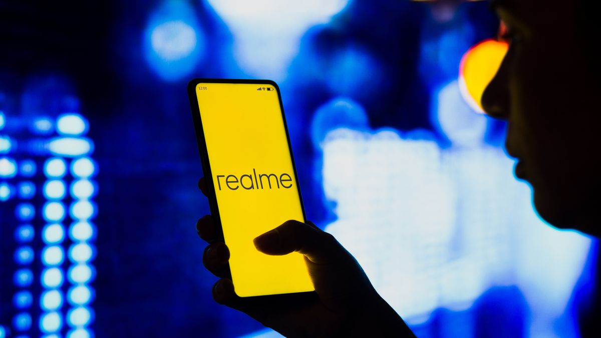 BRAZIL - 2022/05/02: In this photo illustration, a silhouetted woman holds a smartphone with the Realme logo displayed on the screen. (Photo Illustration by Rafael Henrique/SOPA Images/LightRocket via Getty Images)