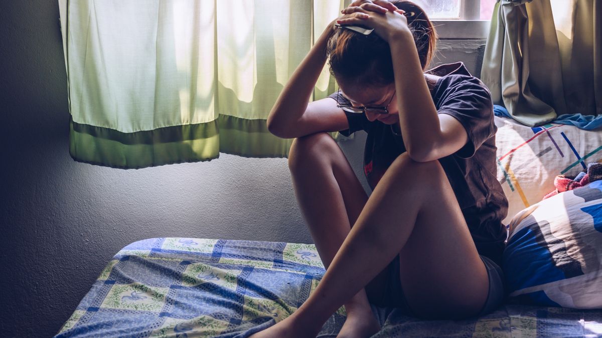 Portrait of depressed/stressed woman sitting alone on the bed in the bedroom.
Conceptual of bad condition of broken hearted, sadness, loneliness woman.
Boy_Anupong