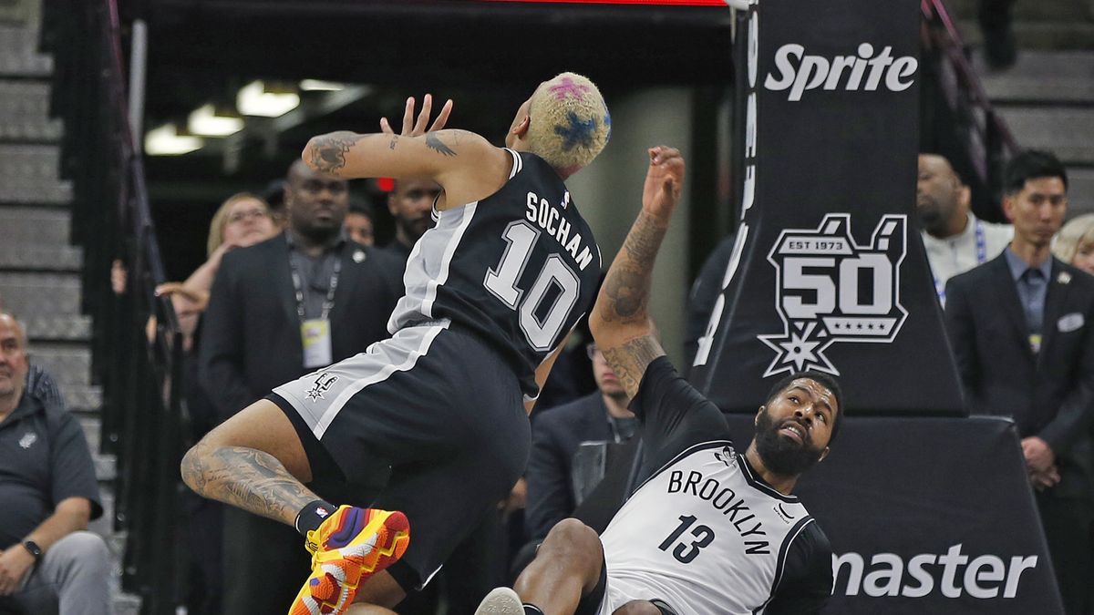 SAN ANTONIO, TX - JANUARY 17:  Jeremy Sochan #10 of the San Antonio Spurs is fouled by Markieff Morris #13 of the Brooklyn Netsn the first half at AT&T Center on January 17, 2023 in San Antonio, Texas. NOTE TO USER: User expressly acknowledges and agrees that, by downloading and or using this photograph, User is consenting to terms and conditions of the Getty Images License Agreement. (Photo by Ronald Cortes/Getty Images)