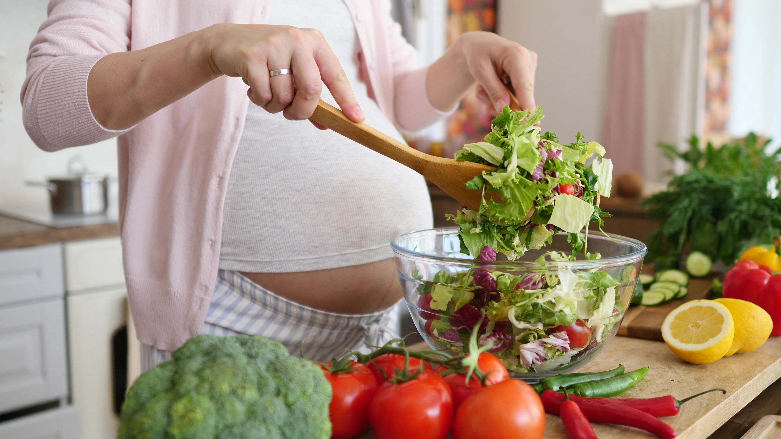 Pregnancy Diet Nutrition Concept. Pregnant Woman Preparing Meal On Kitchen, Making Salad.Pregnancy Diet Nutrition Concept. Pregnant Woman Preparing Meal On Kitchen, Making Salad.pregnant, woman, cooking, healthy, kitchen, food, nutrition, cook, diet, home, meal, people, health, beautiful, breakfast, dinner, female, house, interior, salad, vegetarian, adult, domestic, eat, fresh, happy, indoors, lifestyle, person, prepare, vegetable, young, pregnancy, girl, cut, green, housewife, knife, lunch, preparation, pretty, vegetables, mother, belly, tomatoes, cucumber, vegan, colorful, organic, natural