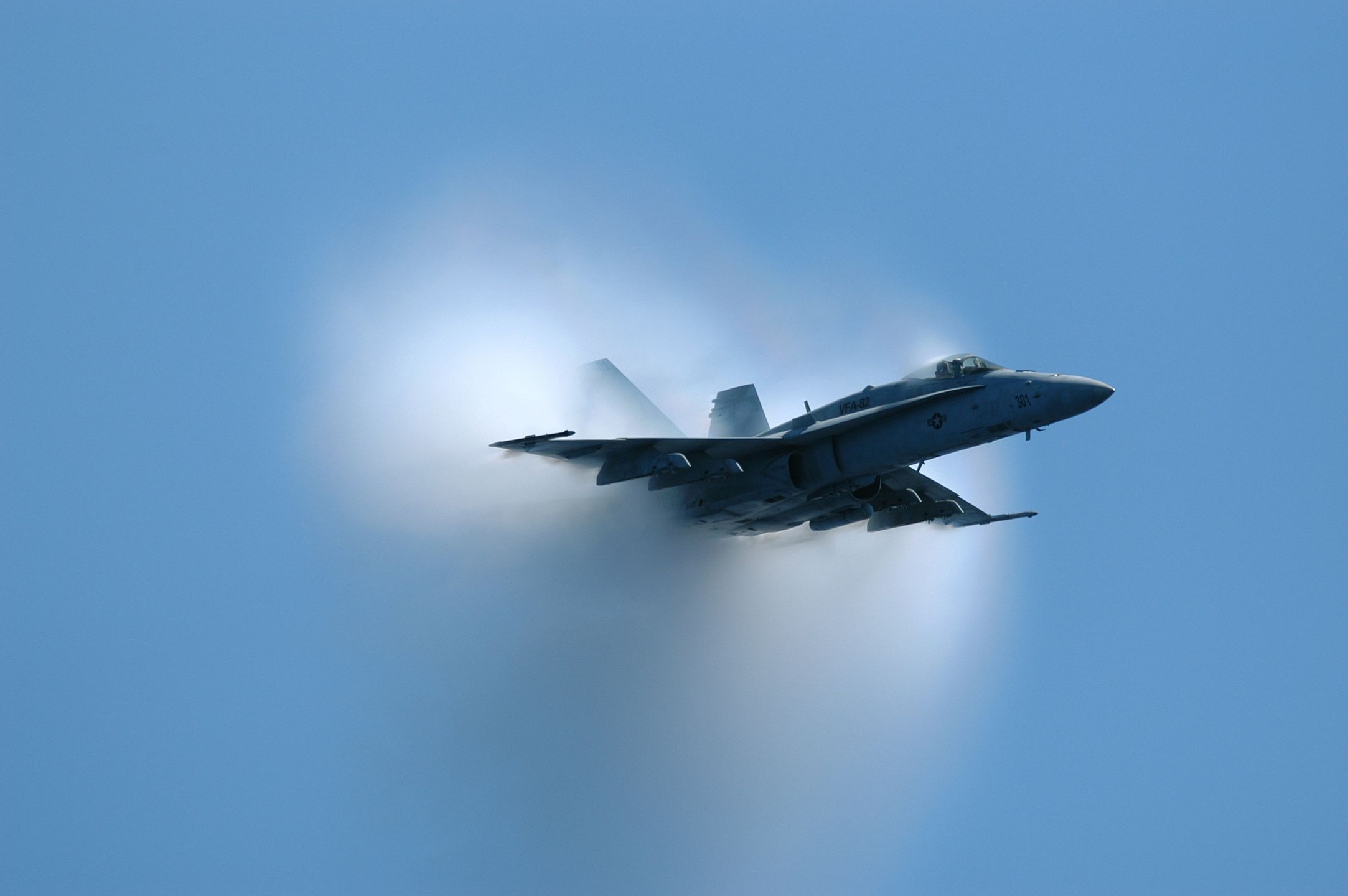 Super Sonic Hornet040609-N-9742R-041
Atlantic Ocean (June 9, 2004) - An F/A-18 Hornet, assigned to the �Marauders� from Strike Fighter Squadron Eight Two (VFA-82), piloted by Lt. Cmdr. James Montgomery, of Yukon, Okla., reaches the sound barrier during a supersonic flyby over USS Enterprise (CVN 65). Enterprise is one of seven aircraft carriers involved in Summer Pulse 2004. Summer Pulse 2004 is the simultaneous deployment of seven aircraft carrier strike groups (CSGs), demonstrating the ability of the Navy to provide credible combat power across the globe, in five theaters with other U.S., allied, and coalition military forces. Summer Pulse is the Navy�s first deployment under its new Fleet Readiness Plan (FRP). U.S. Navy photo by Photographer�s Mate Photographer's Mate 3rd Class Milosz Reterski (RELEASED) For more information go to: http://www.defenselink.mil/releases/2004/nr20040602-0856.htmlPH3  Milosz Reterskisummer pulse, f/a-18, hornet, vfa-82, marauders, supersonic, flyby, sound barrier, sonic boom, vfa 82, uss enterprise, cvn 65, breaks, okla