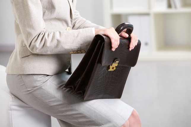 Close-up of businesswoman holding briefcase 