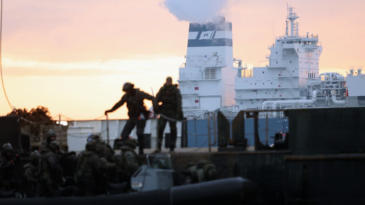Special Task Force police officers monitor the Hoegh Esperanza LNG floating storage regasification unit (FSRU) docking at the Wilhemshaven LNG Terminal in Wilhelmshaven, Germany, on Thursday, Dec. 15, 2022. The inauguration of the import terminal this Saturday will mark an important step for Germany, which has been dependent on Russian pipeline gas for decades and suffered severely since the shipments have stopped this year. Photographer: Liesa Johannsen/Bloomberg via Getty Images