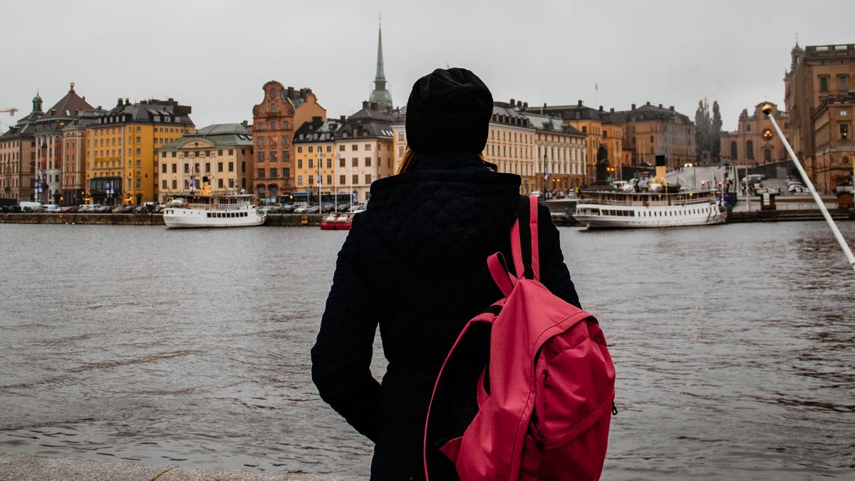 stockholm, sweden, travel, backpack, person, urban, city, skyline, waterfront, harbor, old town, adventure, tourism, scandinavia, europe, european, architecture, historic, cloudy, gloomy, landscape, city life, outdoors, back view, travel photography, urban exploration, capital city, northern europe, pink backpack, water, scenic, picturesque, exploring, journey, vacation, autumn, moody, freedom., tourist, street, woman, people, sky, walking, bridge, river, outdoor, beauty