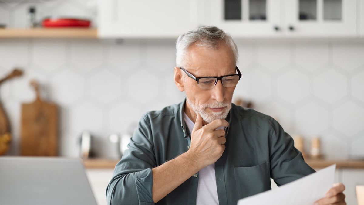 Paperwork Concept. Portrait of senior man working at home officePaperwork Concept. Portrait of senior man working at home office, holding and reading papers or financial document, sitting at desk in kitchen, using pc laptop computer for remote work, closeup shotbusiness,technology,man,house,computer,laptop,home,digital,work,communication,kitchen,glasses,person,old,interior,job,reading,online,device,eyeglasses,screen,elderly,grandfather,gadget,telecommuting,aged,distance,retired,freelance,mature,remote,pensioner,senior,gentleman,documents,papers,career,older,caucasian,white,using,internet,smiling,handsome,copy space,closeup,working,freelancer,entrepreneur,business,technology,man,house,computer,laptop,home,digital,work,communication,kitchen,glasses,person,old,interior,job,reading,online,device,eyeglasses,screen,elderly,grandfather,gadget,telecommuting,aged,distance,retired,freelance,mature,remote,pensioner,senior,gentleman,documents,papers,career,older,caucasian,white,using,internet,smiling,handsome,copy space,closeup,working,freelancer,entrepreneur