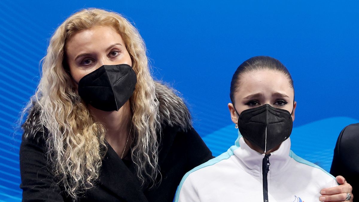 BEIJING, CHINA - FEBRUARY 17: Kamila Valieva of Team ROC reacts to their score with choreographer Daniil Gleikhengauz (R) and coach Eteri Tutberidze (L) after the Women Single Skating Free Skating on day thirteen of the Beijing 2022 Winter Olympic Games at Capital Indoor Stadium on February 17, 2022 in Beijing, China.  (Photo by Matthew Stockman/Getty Images)