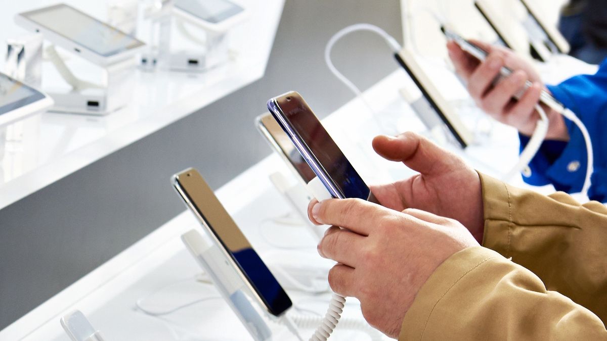 Buyer hands with mobile smartphones in an electronics storestore, smartphone, electronics, product, retail, gadget, phone, technology, modern, business, sale, electronic, mobile, consumer, testing, new, buy, buyer, people, white, hands, device, cellphone, man, presentation, tech, black, looking, digital, industry, interior, shop, commercial, screen, stand, telephone, customer, choice