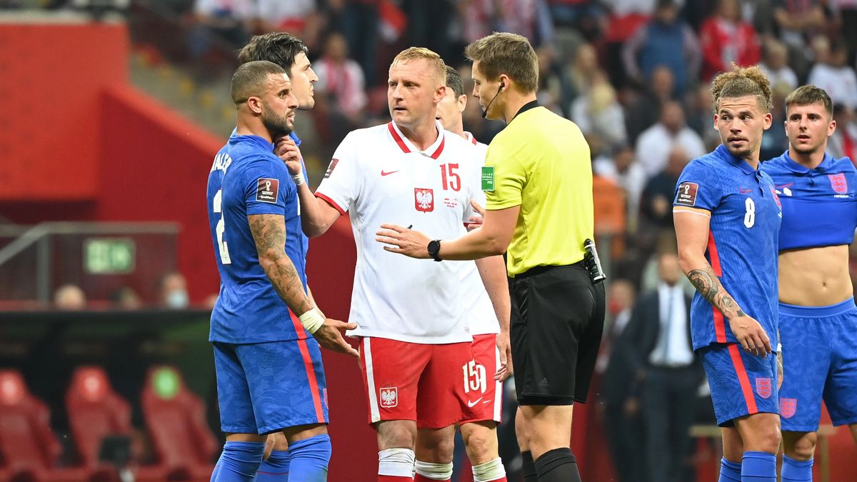 WARSAW, POLAND - SEPTEMBER 08: Kyle Walker of England and Kamil Glik of Poland clash as referee Daniel Siebert talks to them during the 2022 FIFA World Cup Qualifier match between Poland and England at Stadion Narodowy on September 08, 2021 in Warsaw, Poland. (Photo by Ludmila Mitrega - The FA/The FA via Getty Images)