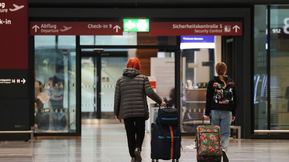 SCHOENEFELD, GERMANY - MARCH 13: People with suitcases walk through a nearly empty departures terminal during a strike at Berlin Brandenburg Airport on March 13, 2023 in Schoenefeld, Germany. Security personnel at Berlin, Bremen, Hamburg and Hanover airports are striking today to demand higher wages. Public sector workers from a variety of professions are striking across Germany this week in an effort by Ver.di, the labour union that represents them, to put pressure on employers in ongoing wage negotiations. (Photo by Sean Gallup/Getty Images)