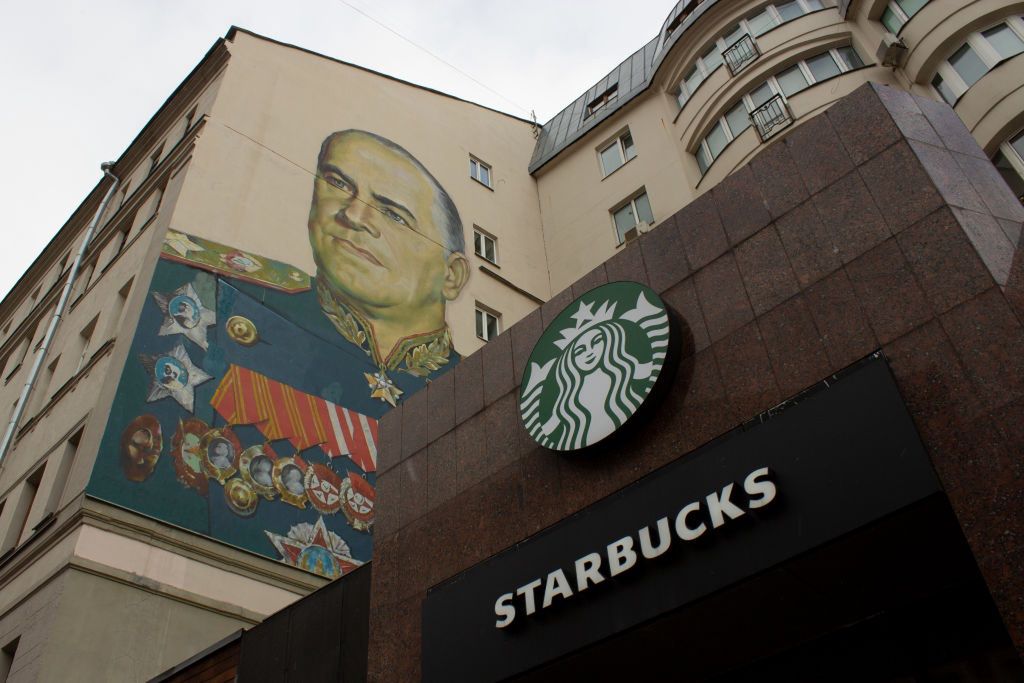 A Starbucks sign is seen alongside the mural of GeorgySOPA Imagescoffeehouse, brand, georgy zhukov, suspended, suspended business