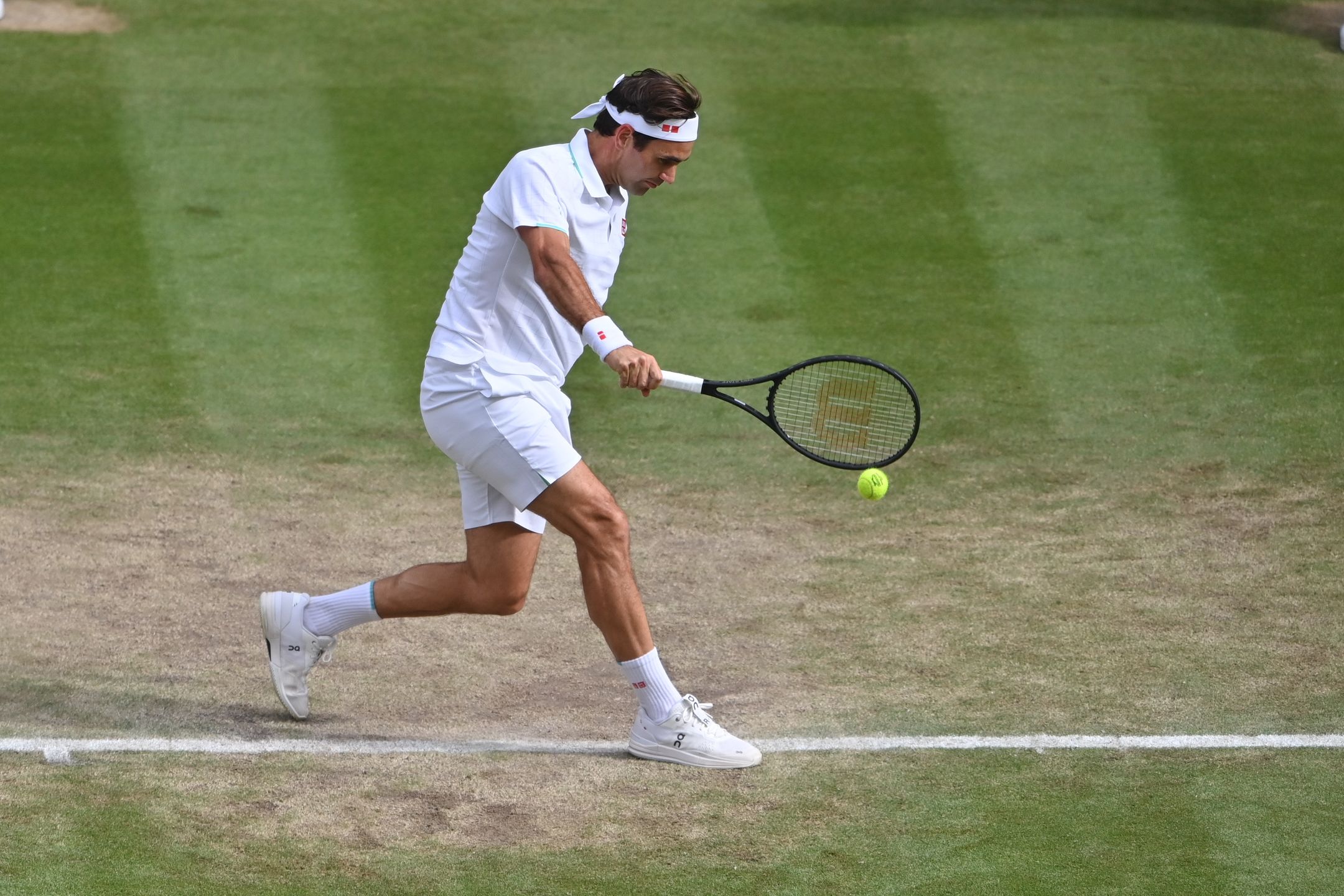 LONDON, ENGLAND - JULY 07: Roger Federer of Switzerland hits a backhand against Hubert Hurkacz of Poland in the quarter finals of the gentlemen's singles during Day Nine of The Championships - Wimbledon 2021 at All England Lawn Tennis and Croquet Club on July 07, 2021 in London, England. (Photo by TPN/Getty Images)