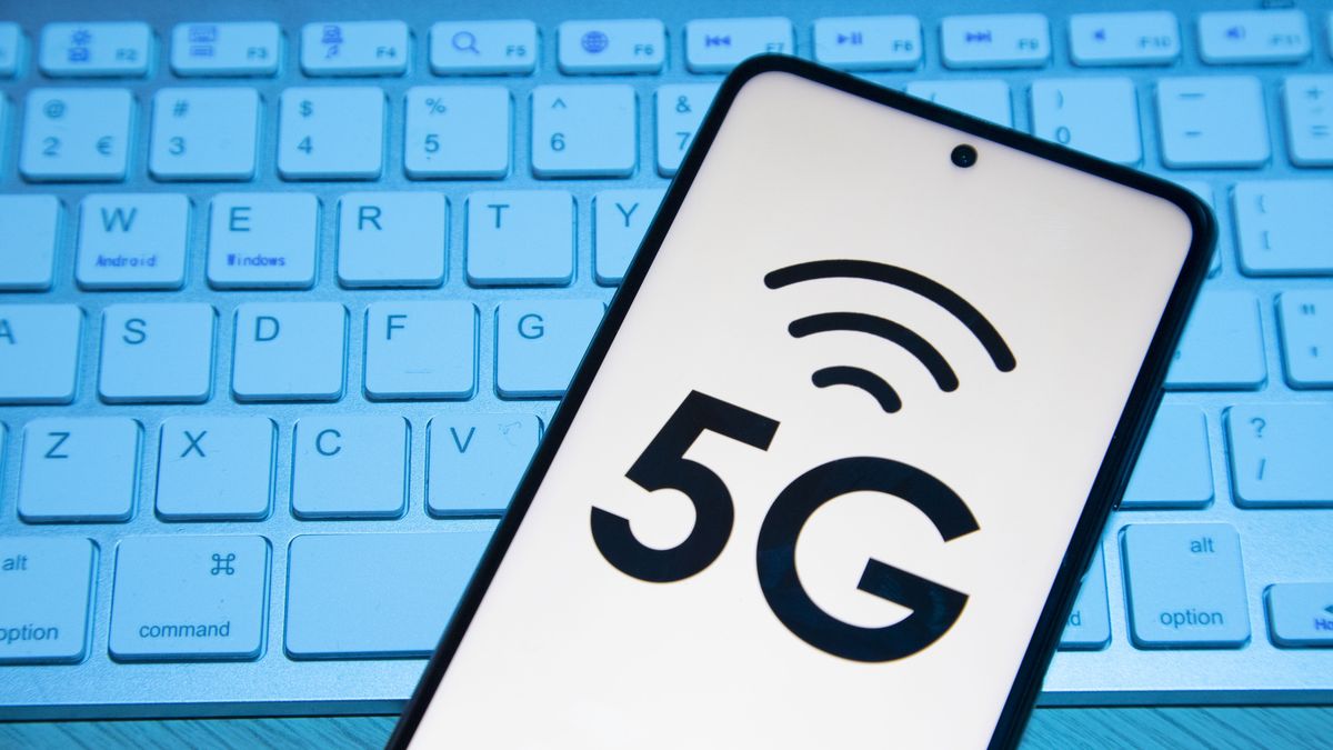 Photo illustration of a 5G signal symbol logo displayed on a smartphone display on top of a keyboard. Eindhoven, the Netherlands on January 27, 2022 (Photo Illustration by Nicolas Economou/NurPhoto via Getty Images)