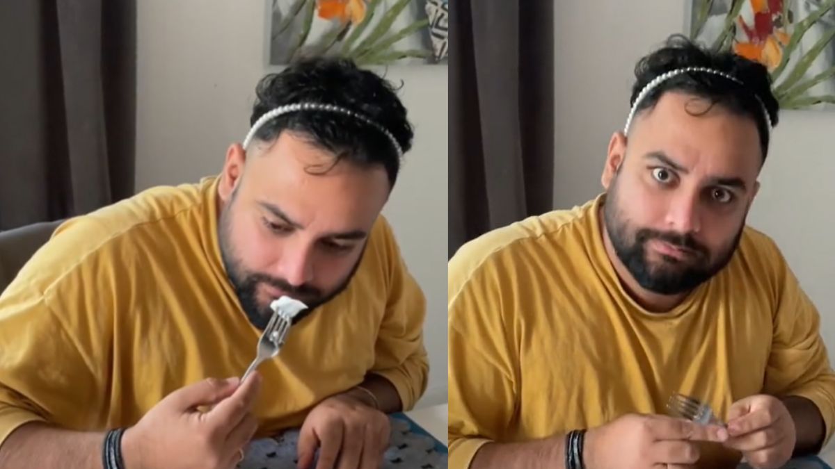 Mężczyzna z Indii próbuje śledzia w śmietanie