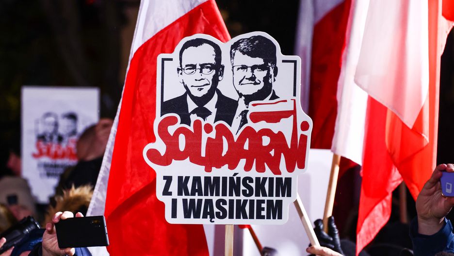 'Solidarity with Kaminski and Wasik' banner is seen during right-wing 'Free Poles Protest' in front of parliament building in Warsaw, Poland on January 11, 2024. Members of the previous government called people to demonstrate against new pro-EU government which dismissed executives from state media which served the right-wing Law and Justice Party during its eight years in power. Protestors also demonstrated against the arrest of Mariusz Kaminski and Maciej Wasik, lawmakers for Law and Justice (PiS) party, sentenced to two years in prison for abuse of power in 2007, when they were in charge of the anti-corruption agency CBA. (Photo by Beata Zawrzel/NurPhoto via Getty Images)