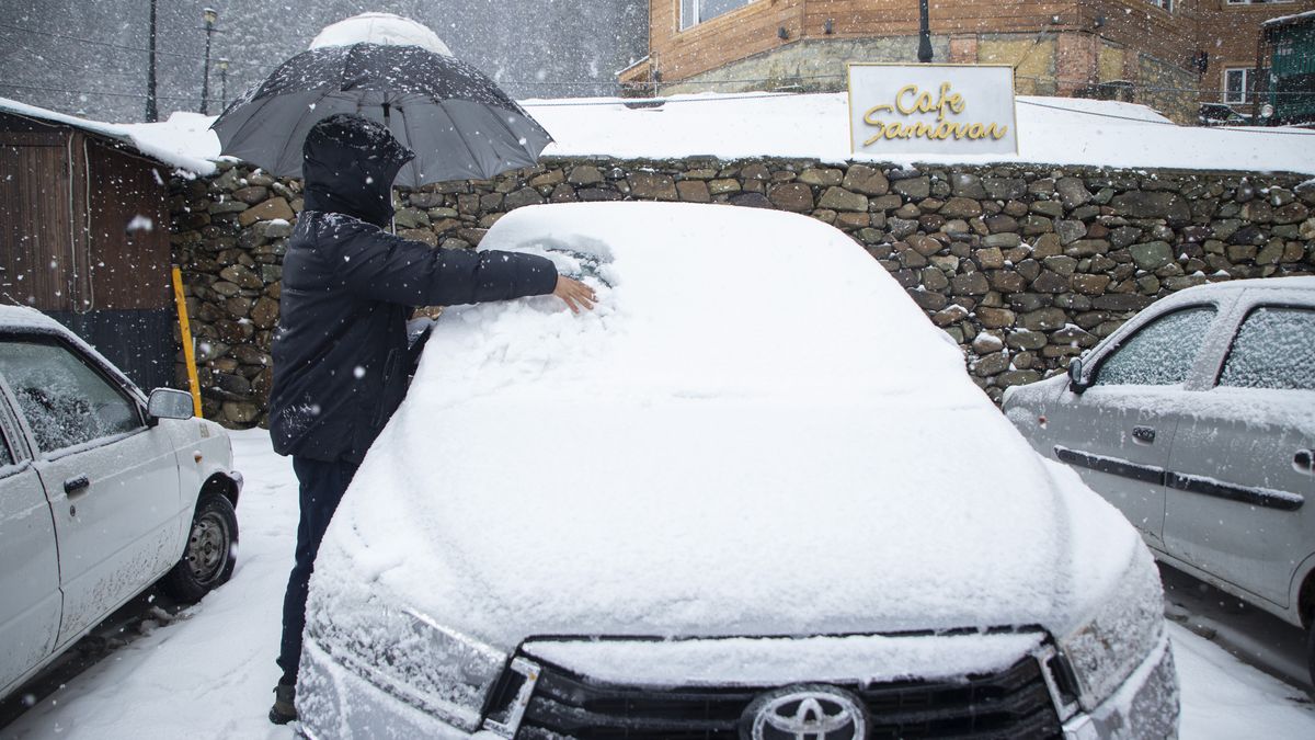 GULMARG, JAMMU AND KASHMIR, INDIA - 2025/12/21: A Kashmiri man clears snow from a car during a fresh snowfall in Gulmarg, north of Srinagar. Fresh snowfall in Gulmarg on Sunday signaled the onset of Chillai-Kalan, the harshest 40-day winter period in Kashmir beginning December 21. The severe winter phase, locally known as Chillai-Kalan, brings subzero temperatures across the Himalayan region. During this period, temperatures can plunge to as low as minus 20 degrees Celsius (minus 4 degrees Fahrenheit), triggering intense cold waves. Water bodies, including the world-famous Dal Lake, often freeze, while water supply lines in several parts of the valley face disruption. (Photo by Faisal Bashir/SOPA Images/LightRocket via Getty Images)