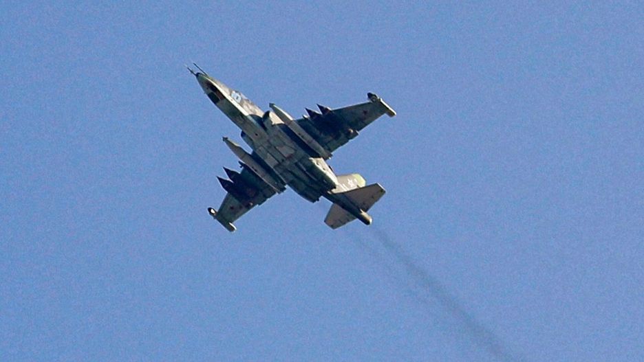 arch44(FILES) This file photo taken on February 1, 2018, shows a Russian air force Sukhoi-25 fighter jet flying over the Syrian city of Saraqib, southwest of Aleppo. - A wave of 130 Russian air strikes carried out over the past 24 hours killed at least 21 Islamic State group jihadists in the Syrian desert over the past 24 hours, a war monitor said today. (Photo by OMAR HAJ KADOUR / AFP)OMAR HAJ KADOUR