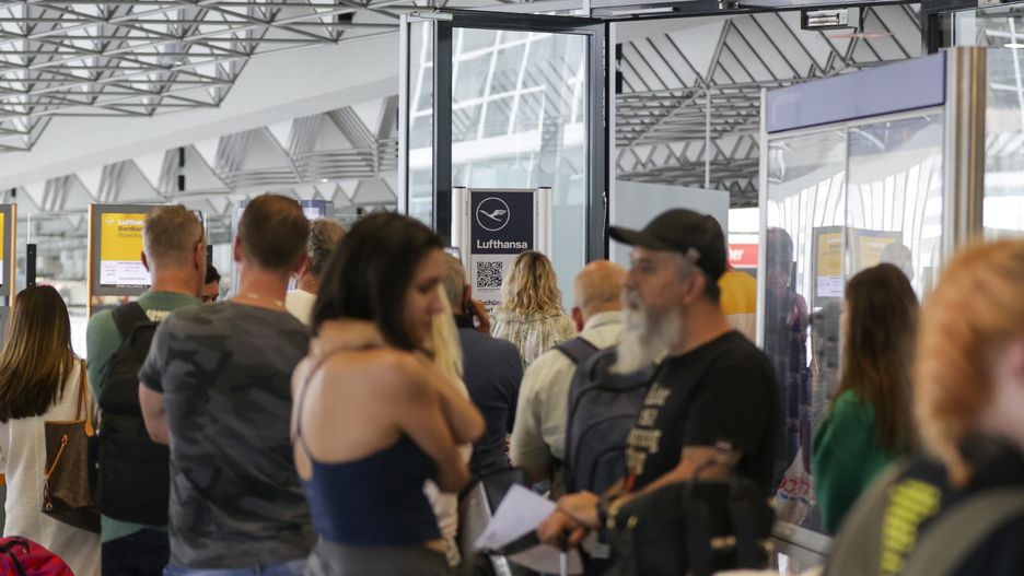 Travelers queue at a customer service center for Deutsche Lufthansa AG at Terminal 1 of Frankfurt Airport in Frankfurt, Germany, on Friday, June 24, 2022. Lufthansa canceled 2,200 flights after a wave of coronavirus infections worsened staffing shortages, adding to Europes travel chaos as the crucial summer vacation period gets under way. Photographer: Alex Kraus/Bloomberg via Getty Images