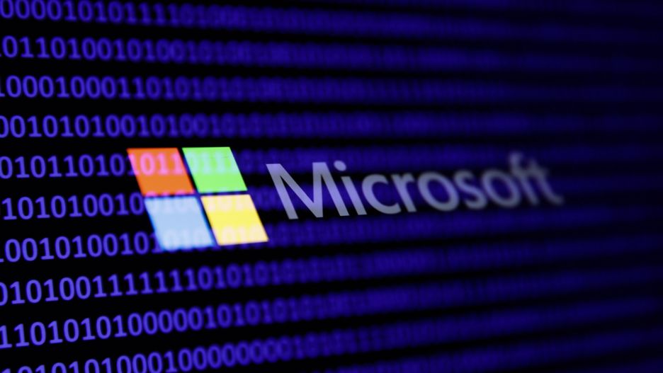 A binary code and Microsoft logo are seen in this multpiple exposure illustration photo taken in Krakow, Poland on February 21, 2024. (Photo by Jakub Porzycki/NurPhoto via Getty Images)