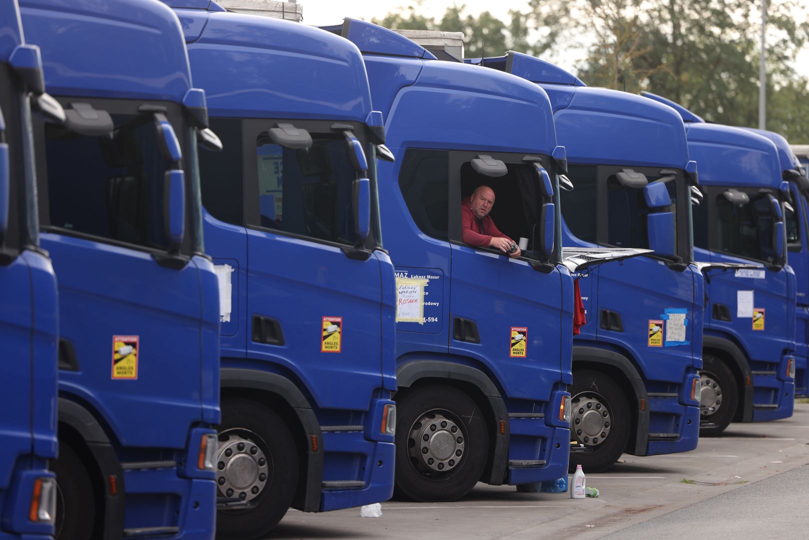 DARMSTADT, GERMANY - SEPTEMBER 20: A striking truck driver sits in his truck at the Graefenhausen West highway rest area on the second day of a hunger strike by about 30 of his colleagues on September 20, 2023 near Darmstadt, Germany. The approximately 80 truck drivers from countries including Georgia, Uzbekistan and Tajikistan have been living at the rest area in their trucks since they went on strike against their Polish employer, Lukasz Mazur, two months ago over missing pay. Local politicians and trade unionists have been supporting the truckers, though so far Mazur has refused to negotiate and instead has filed a lawsuit against the truckers over extortion. Edwin Atema, a trade unionist from Holland who is helping the truckers legally, says their case is an example of a much larger problem of labor exploitation of truckers across Europe. (Photo by Sean Gallup/Getty Images)