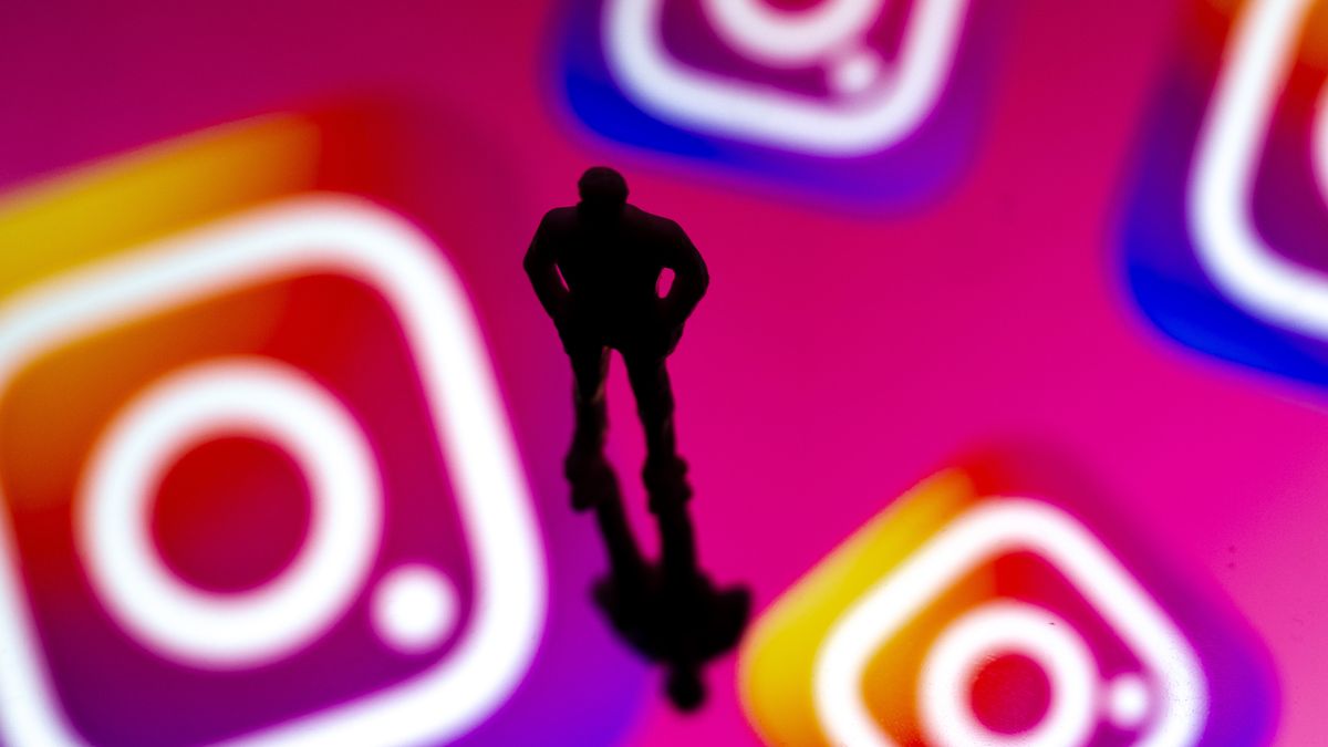 ANKARA, TURKIYE - OCTOBER 03: A silhouette of a miniature figure is seen in front of a computer screen displaying the logos of Instagram in Ankara, Turkiye on October 03, 2025. (Photo by Ismail Aslandag/Anadolu via Getty Images)