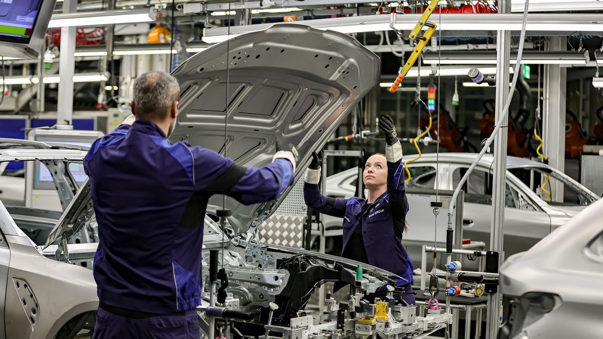 MUNICH, GERMANY - DECEMBER 05: Members of BMW's manufacturing staff inspect a vehicle's finish as hetheyworks at the body shop finish during German Chancellor Olaf Scholz visits the BMW Group car factory on December 05, 2023 in Munich, Germany. His visit is taking place as Scholz's government wrestles with a federal budget crisis stemming from a recent Federal Constitutional Court ruling. (Photo by Leonhard Simon/Getty Images)