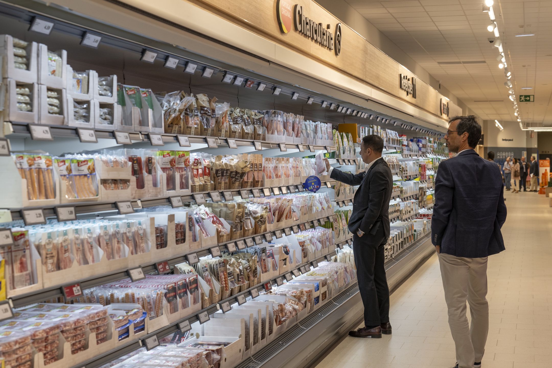 LISBON, PORTUGAL - APRIL 18: Special guests check products at the cold cuts section while visiting Lidl new supermarket on inauguration day at Restelo stadium sports complex on April 18, 2024, in Lisbon, Portugal. The ceremony was attended by representatives of Lisbon City Council, Belenenses, Lidl Portugal, and special guests. Lidl, a supermarket chain of German origin, that belongs to the Schwarz Group, entered the Portuguese market in 1995, and has now 270 stores in the country. (Photo by Horacio Villalobos#Corbis/Corbis via Getty Images)