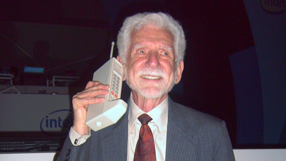 Martin Cooper, zwany ojcem telefonii komórkowej, trzyma Motorolę