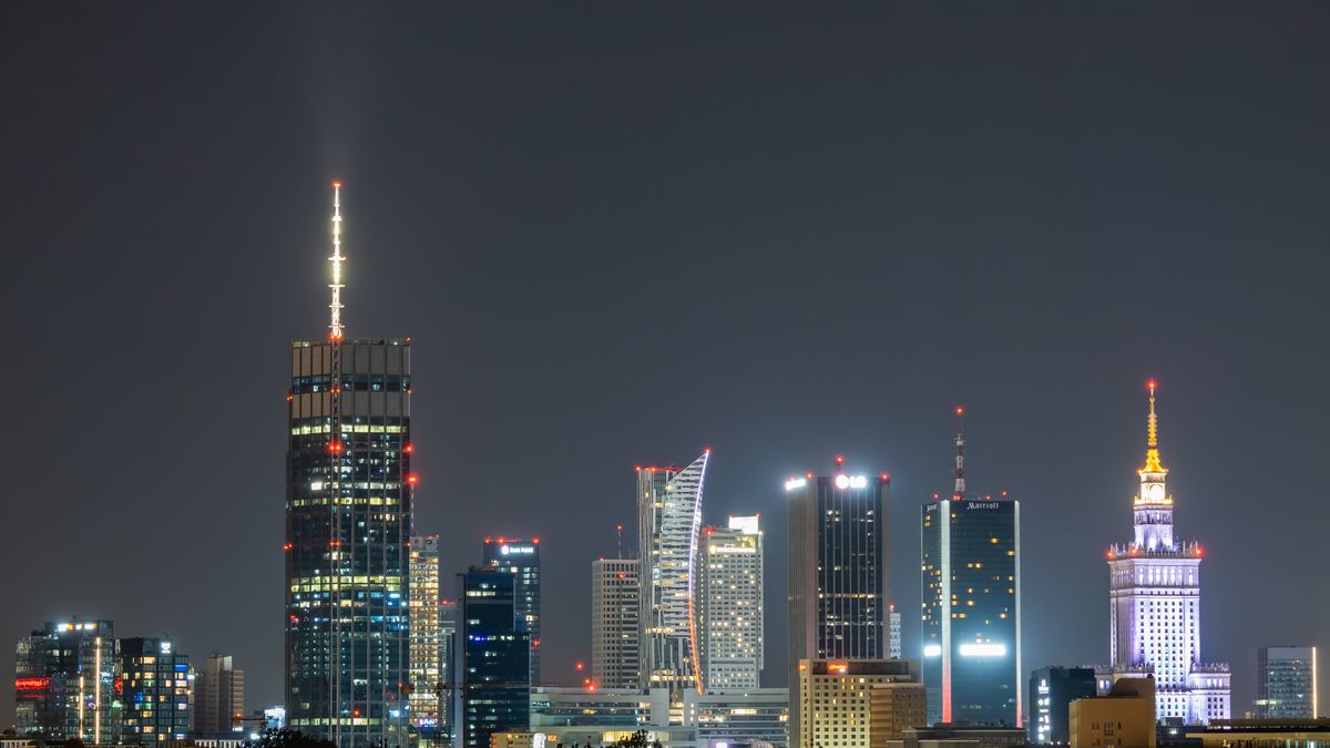 WARSAW, POLAND - 2024/08/17: General overview of the illuminated modern cityscape during night time with skyscrapers of the capital of Poland Warsaw. Highest building of the European Union Varso tower seen on the left and iconic Palace of Culture and Science (in Polish Palac Kultury i Nauki) on the right. Warsaw is the largest city in Poland and its economic and business centre is a home to 13 skyscrapers buildings, which are at least 150 meters tall. (Photo by Tomas Tkacik/SOPA Images/LightRocket via Getty Images)