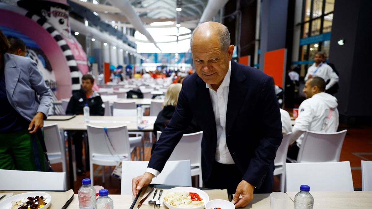 PARIS, FRANCE - JULY 27: German Chancellor Olaf Scholz joins members of the German Olympic team in the canteen as he visits the German Olympic team at the Olympic Village on day one of the Olympic Games Paris 2024 on July 27, 2024 in Paris, France. (Photo by Sarah Meyssonnier  Pool/Getty Images)