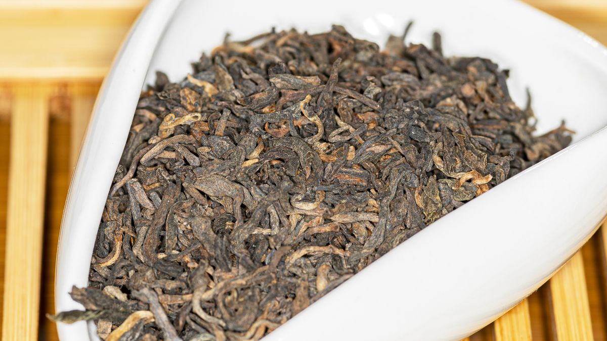 Chinese bulk extruded tea ripe Puer in tea presentation vesselChinese bulk extruded tea ripe Puer in tea presentation vessel, macro image with blurred background, square photoDenis Gavrilov