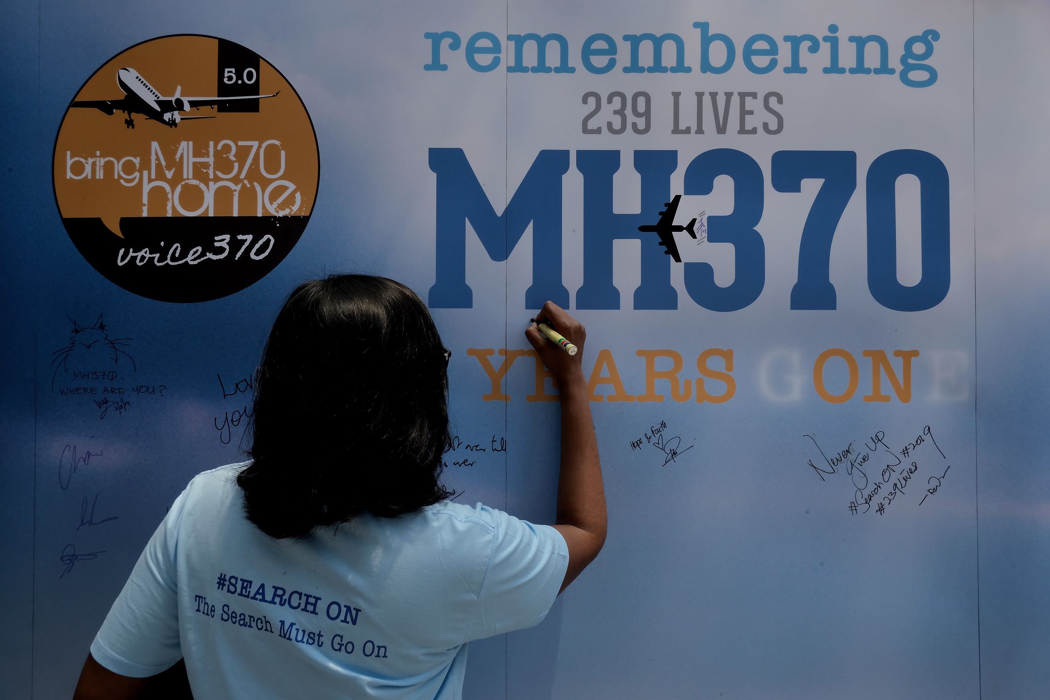 5 Years Remembrance Flight MH370KUALA LUMPUR, MALAYSIA - MARCH 03: A family member writes on a message board for passengers, onboard the missing Malaysia Airlines Flight MH370 during a 5 Years of Remembrance for Malaysian Airlines MH370 event on March 3, 2019 in Kuala Lumpur, Malaysia. The Boeing 777-200 plane heading from Kuala Lumpur to Beijing with 239 passengers and crew went missing on March 8, 2014. According to  Malaysias transport minister Anthony Loke, government is waiting for a fresh proposal from US exploration firm Ocean Infinity or any other interested party before resuming the search for ill-fated flight MH370, five years after tragedy the Malaysian Airlines MH370 flight still on mysery. (Photo by Mohd Samsul Mohd Said/Getty Images)Mohd Samsul Mohd Saidhuman interest, malaysia airlines, lifestyles, travel, spirituality, cultures, kuala lumpur, lifestyle, sprituality, mh370