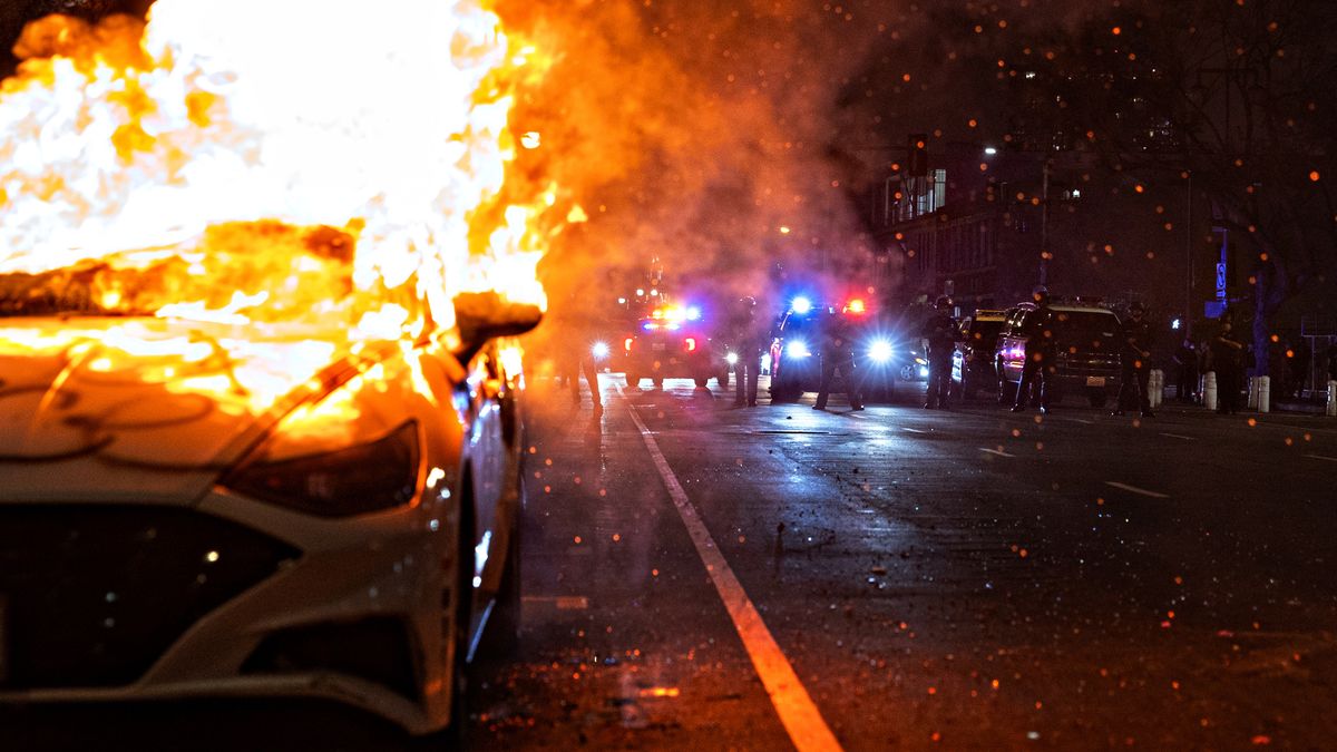 Los Angeles, CA - June 09: A car burns on East 3rd street after protesters set a car on fire as demonstrators continue to clash with the Los Angeles Police Department in downtown Los Angeles due to the immigration raids in L.A. on Monday, June 9, 2025 in Los Angeles, CA. (Jason Armond / Los Angeles Times via Getty Images)