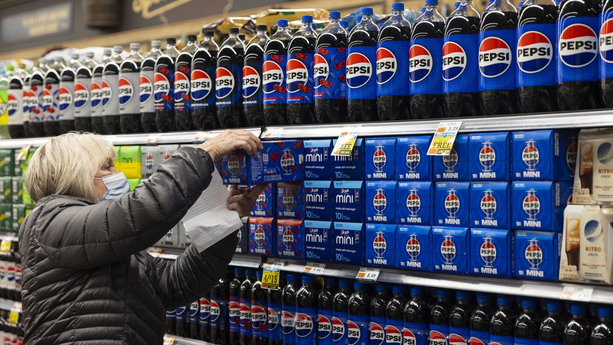 A shopper picks up a case of Pepsi cans from a shelf in a supermarket in Latham, New York, US, on Friday, Feb. 2, 2024. PepsiCo Inc. is scheduled to release earnings figures on February 9. Photographer: Angus Mordant/Bloomberg via Getty Images