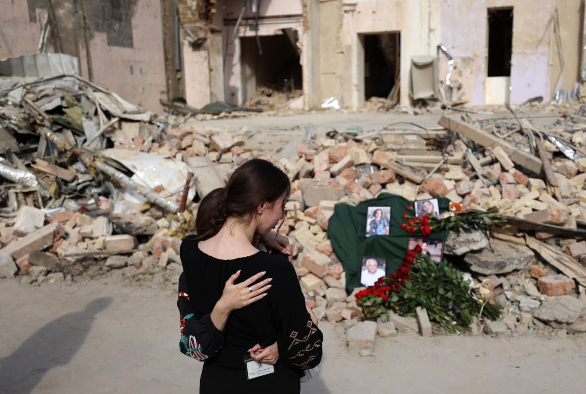 Flowers and photos of victims at the hospital debris