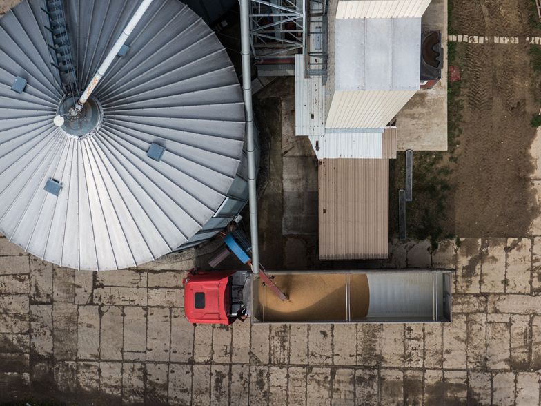 ROGOW, POLAND - SEPTEMBER 25: An aerial view showing a truck loading wheat from silos in Wieslaw agricultural farm on September 25, 2023 in Rogow, Poland. Wieslaw, who manages an agricultural farm, a family business since 1785. This year he sold 800 tones of wheat 30% under the market price and has 3000 tones of the same product in storage without a buyer as throughout the year, Ukrainian wheat flooded the Polish market. His farm, annually produces an average of 4000 tones of wheat, 3000 tones of corn and also white beet.  Trade and diplomatic issues between Ukraine and Poland surrounding honey, wheat, corn, rapeseed and sunflower seeds produced in Ukraine have sparked discord. (Photo by Omar Marques/Getty Images)