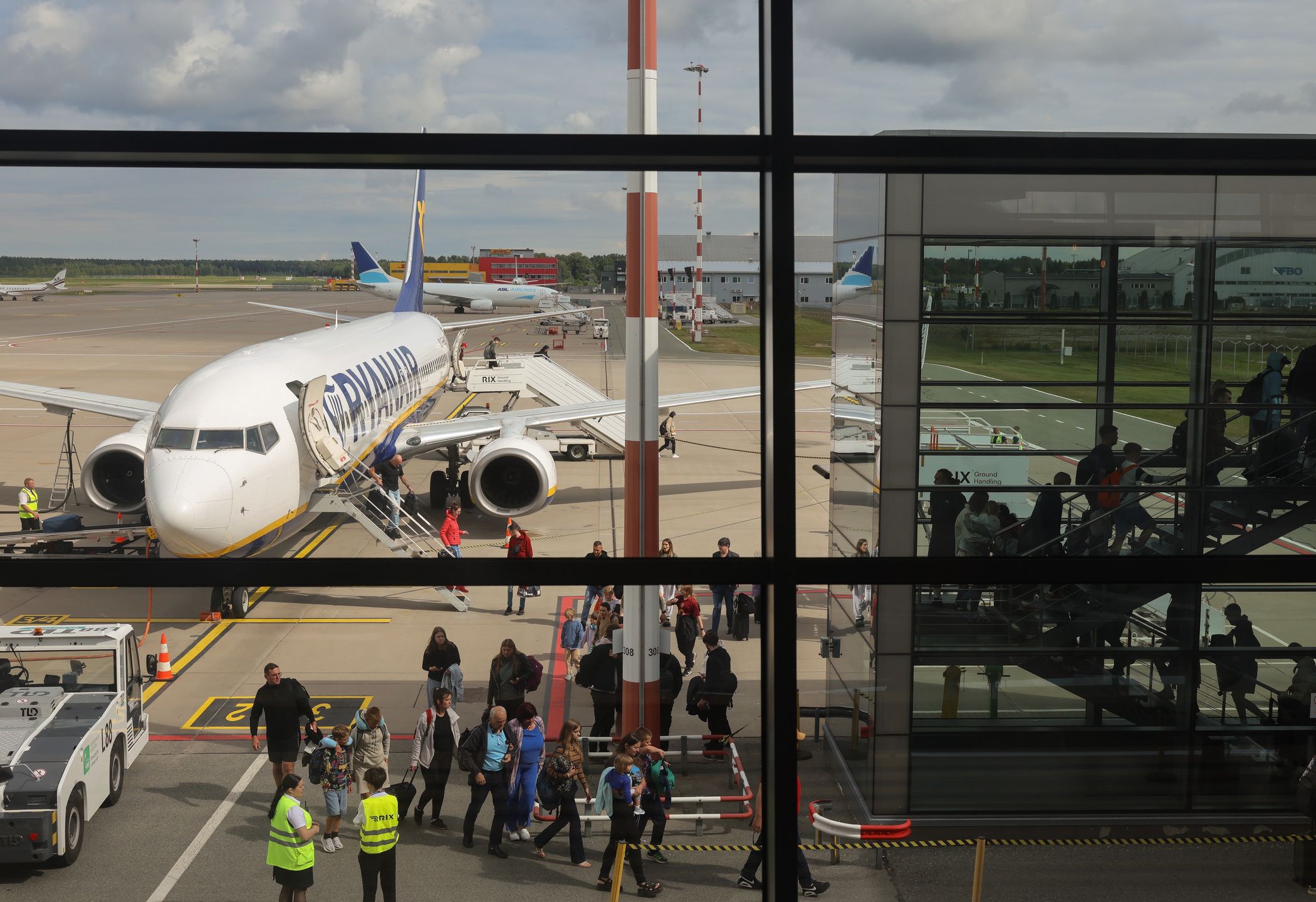 Passengers disembark a Ryanair Holdings Plc, passenger jet at Riga International Airport, in Riga, Latvia, on Wednesday, July 23, 2025. European airlines may face a nervous wait for summer yield as peak capacity ramps up, given the later bookings trend highlighted by Jet2 and EasyJet. Photographer: Andrey Rudakov/Bloomberg via Getty Images