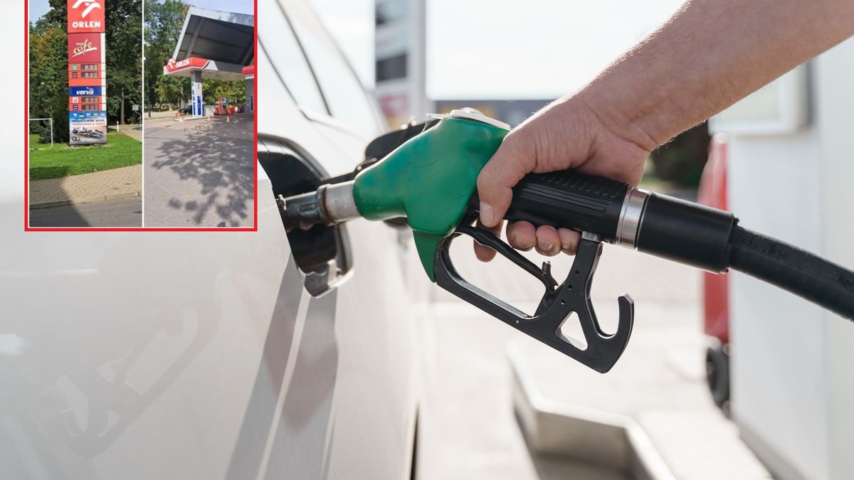 Man's hand holding green petrol pump and feeling car