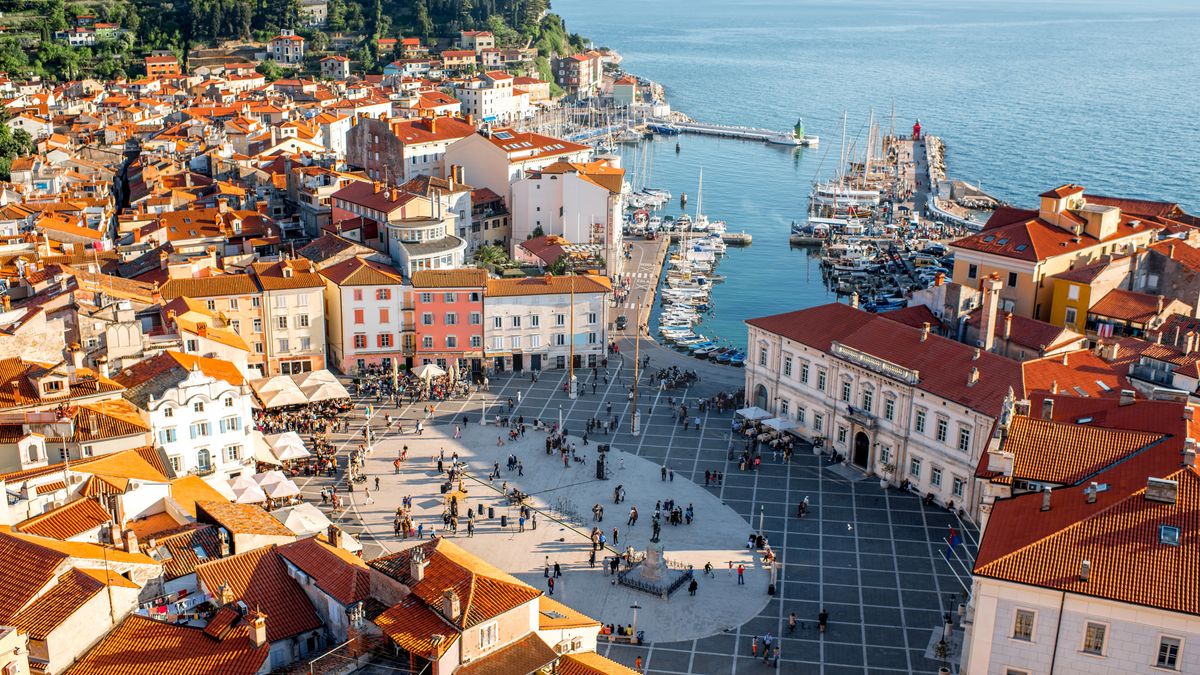 Aerial view on Piran town
Beautiful aerial view on Piran town with Tartini main square, ancient buildings with red roofs and Adriatic sea in southwestern Slovenia
piran, slovenia, city, adriatic, travel, summer, old, architecture, tourism, europe, historic, town, medieval, view, destination, slovenian, cityscape, seaside, venetian, coastal, roofs, top, aerial, scape, buildings, square, crowded, sunset, sunny, sea, bay, marina, gulf, tartini, ancient