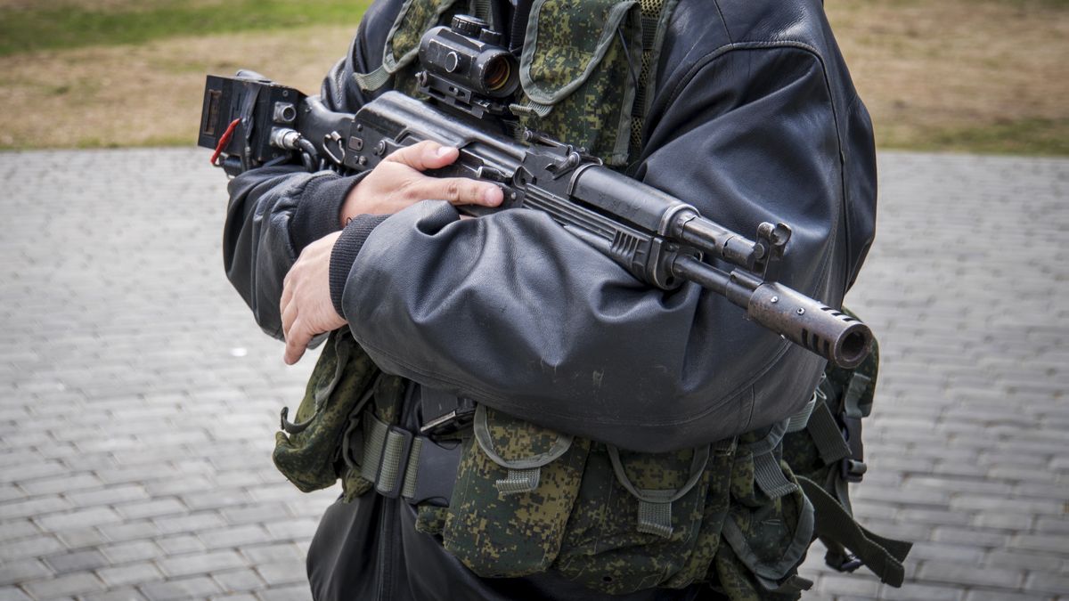 a man with a machine guna man with a machine gun. male men's hands holding a rifle. Irregular troops. unprofessional military. Militiaman. Kalashnikov assault rifle with laser sniper scope. separatistsDiy13armed, firearm, man, terrorist, dangerous, killer, shooting, violent, assassin, assault, bad, kill, outlaw, robber, robbery, illegal, racketeering, donbass, lugansk, defender, soldier, russian, civil, guardsman, separatists