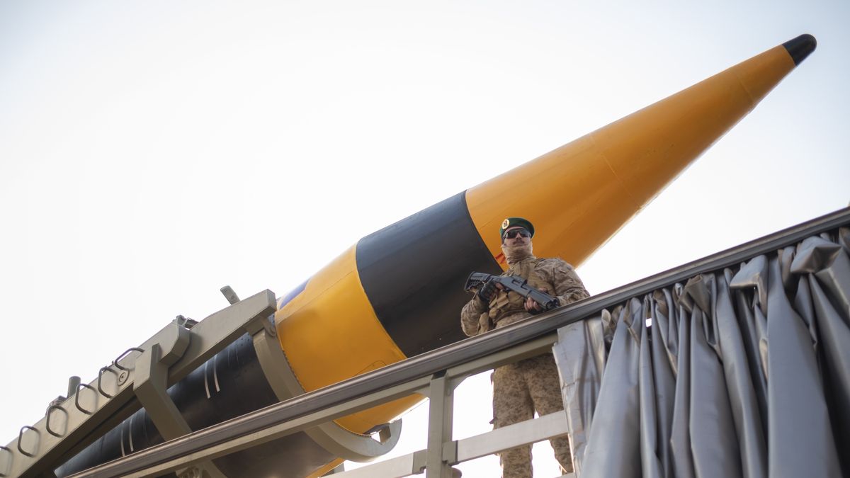An Islamic Revolutionary Guard Corps (IRGC) armed military personnel is monitoring an area while standing guard next to an Iranian Kheibar Surface-to-Surface missile, during the Ela Beit Al-Moghaddas (Al-Aqsa Mosque) military rally in Tehran, Iran, on November 24, 2023. The IRGC is unveiling two new missiles during the rally. (Photo by Morteza Nikoubazl/NurPhoto via Getty Images)