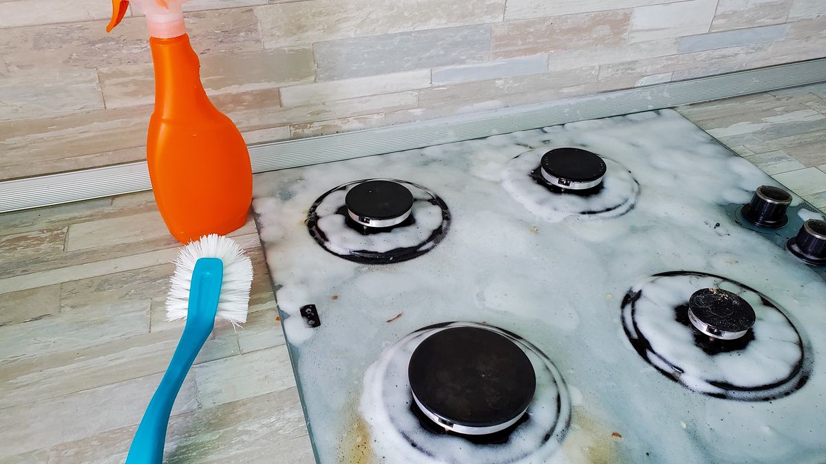 Surface of the gas stove is covered with foam to remove fat and burnt food residuesSurface of the gas stove is covered with foam to remove fat and burnt food residues.stove, gas, cleaning, kitchen, house, cleaner, housework, glass ceramics, dirty, home, household, housewife, detergent, clean, work, rag, hygiene, sponge, washing, bottle, spray, burner, surface, metal, foam, polishing, background, contemporary, cleanser, human, appliance, chemical, working, wash, woman, wet, cooker, glass, oven, care, wipe, cleaning service, rubber, cleanliness, modern, gas stove, hand, purity