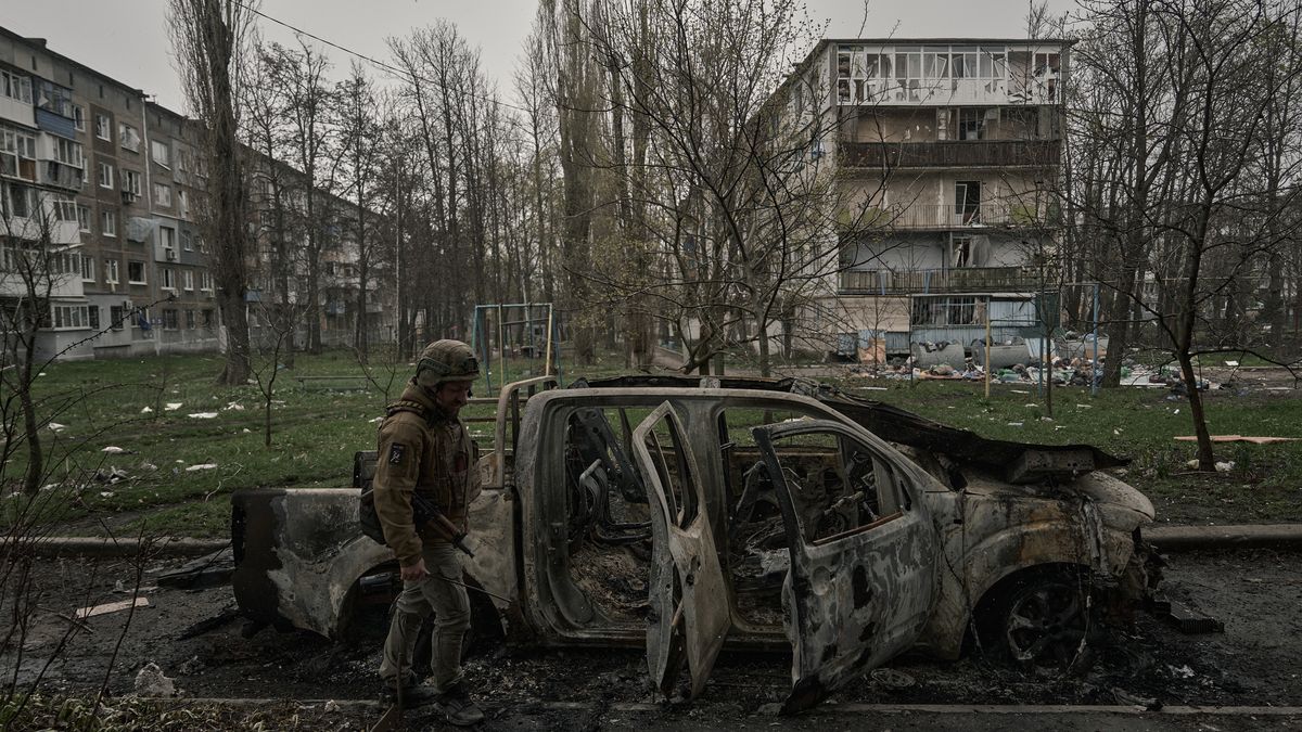 POKROVSK, UKRAINE - APRIL 8: A soldier walks past a destroyed car on April 8, 2025 in Pokrovsk, Ukraine. Civilian life in a city that is now almost on the front line with entry and exit from the city controlled by Russian FPV drones. There is no way for police or volunteers to enter the city.  (Photo by Kostiantyn Liberov/Libkos/Getty Images)