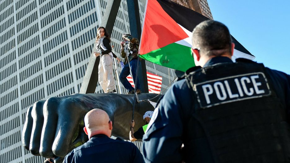 Temporary
DETROIT, MICHIGAN - OCTOBER 5, 2024: A protester waves a Palestinian flag on top of the Joe Louis Fist as Detroit Police officers ask them to climb down while several hundred other activists and community members gather to hold a rally march marking one year of anti-war and genocide protests and to continue their demands for divestment, an arms embargo on Israel, and for permanent ceasefires in Gaza, Lebanon, and Yemen in downtown Detroit, Michigan, United States on October 5, 2024 Adam J. Dewey / Anadolu/ABACAPRESS.COM
AA/ABACA