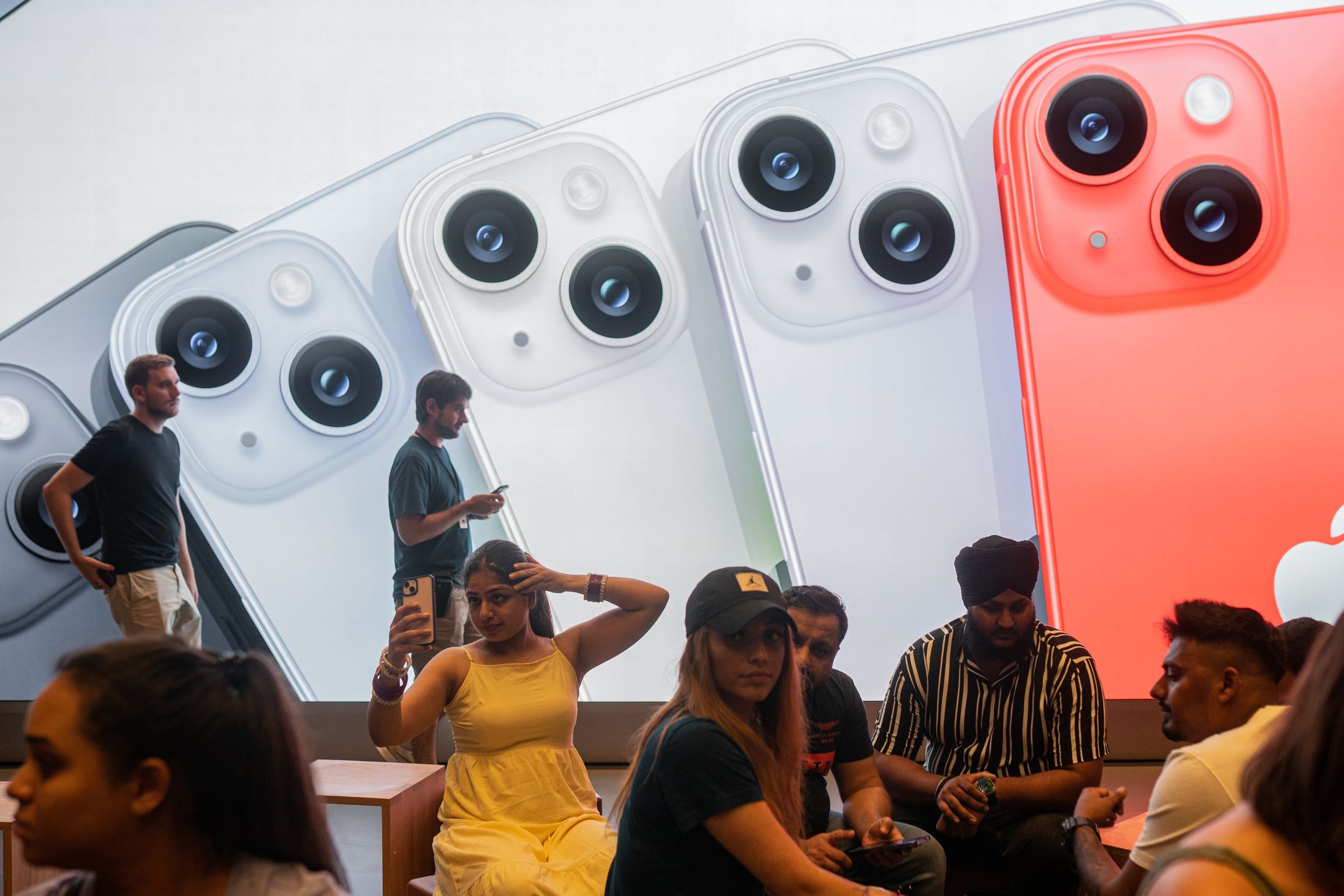 Apple salespeople serve customers who want to buy the new iPhone 14 and exchange impressions and advise them, in Barcelona, Spain, on September 16, 2022. (Photo by Marc Asensio/NurPhoto via Getty Images)