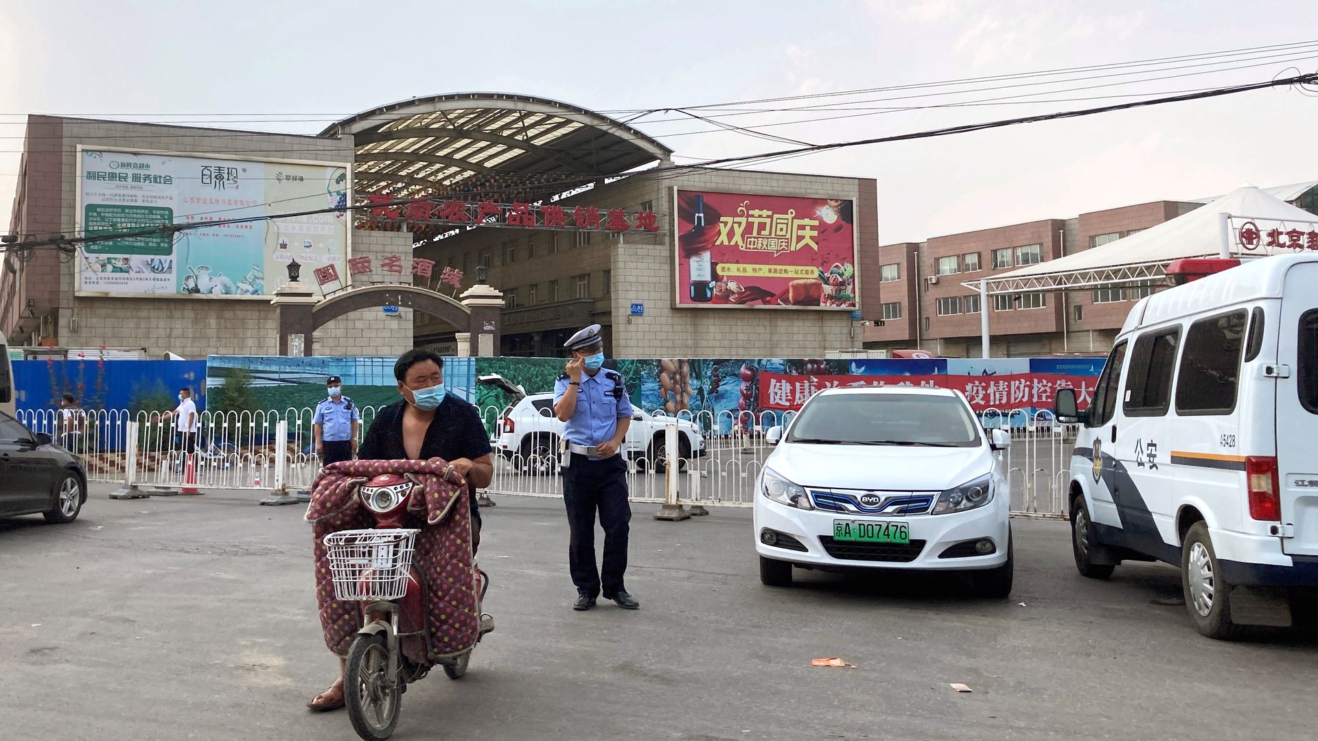 Policja przed zamkniętym targiem Xinfadi.