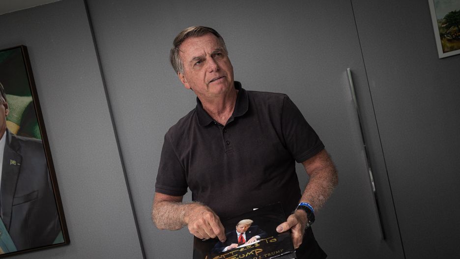Jair Bolsonaro, Brazil's former president, during an interview in Brasilia, Brazil, on Tuesday, Jan. 28, 2025. In the photo he shows a book that was gifted to him by presidente Donald trump. To Bolsonaro, Donald Trump's return to the White House justifies the political faith that he invested in his fellow president and regards Trump as his potential path to political redemption. Photographer: Arthur Menescal/Bloomberg via Getty Images