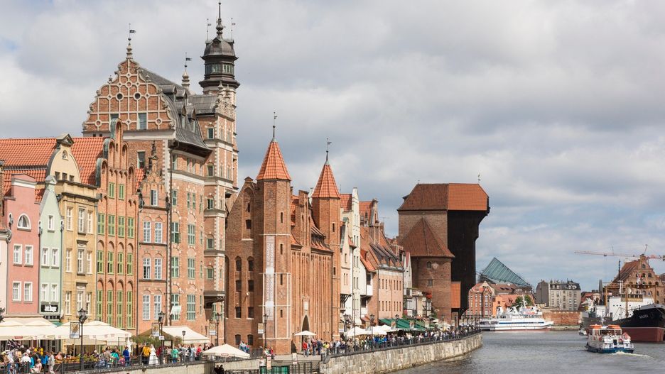 Danzig, Poland - July 7 2016: Gdansk old city in Poland with the oldest medieval port crane (Zuraw) in Europe and a promenade along the riverbank of Motlawa River